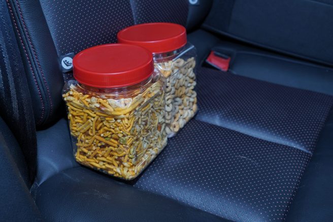 An image of two large plastic bottles filled with dry snacks and cereals.